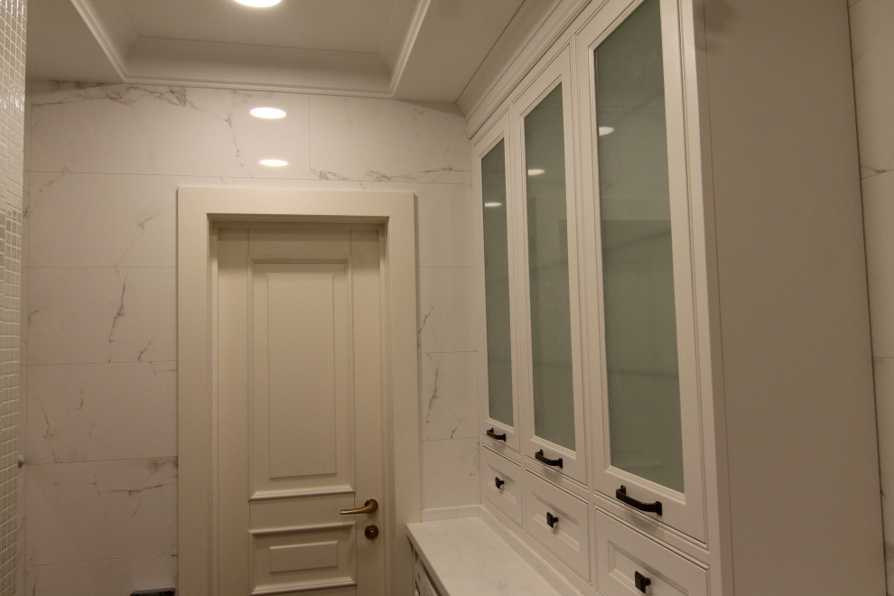 Medium sized traditional grey and white ensuite bathroom in Moscow with glass-front cabinets, white cabinets, an alcove bath, a shower/bath combination, black and white tiles, ceramic tiles, a built-in sink, solid surface worktops, a shower curtain, white worktops, a laundry area, a single sink and a built in vanity unit.
