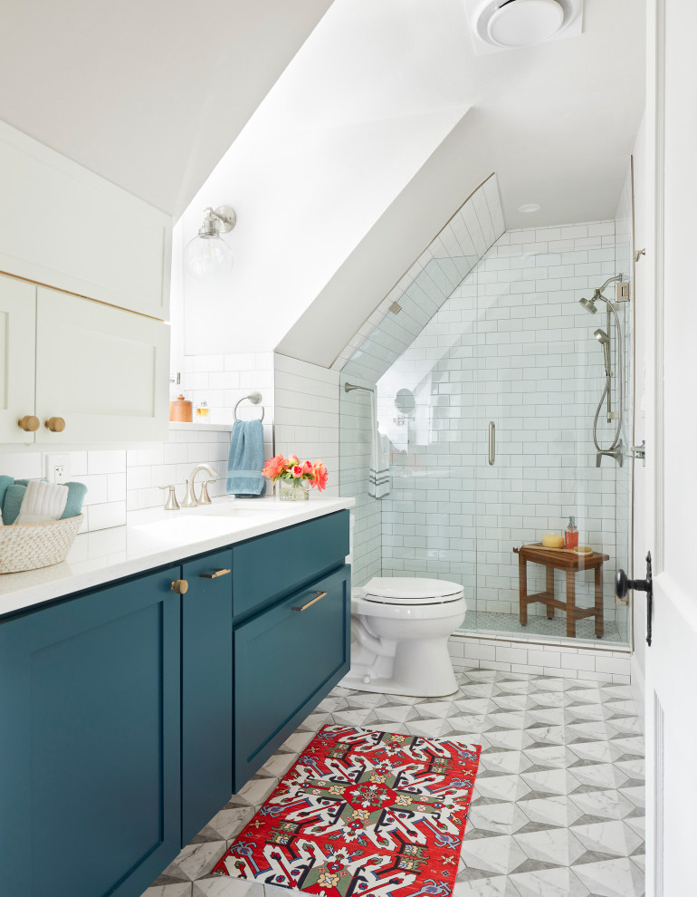 Photo of a small transitional master bathroom in Other with shaker cabinets, blue cabinets, a two-piece toilet, white tile, subway tile, white walls, ceramic floors, an undermount sink, engineered quartz benchtops, grey floor, a hinged shower door, white benchtops, a single vanity and a floating vanity.