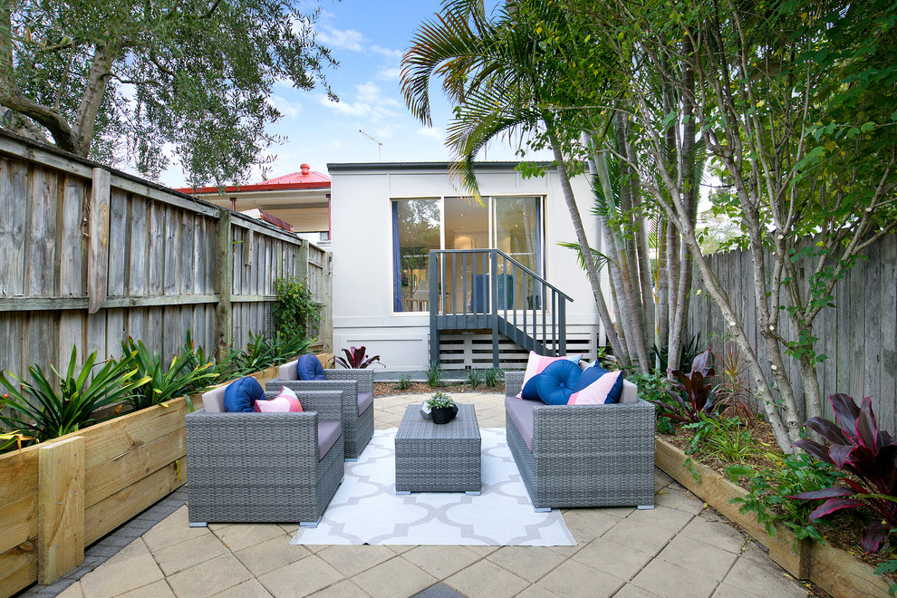 Photo of a contemporary backyard patio in Sydney with concrete pavers.