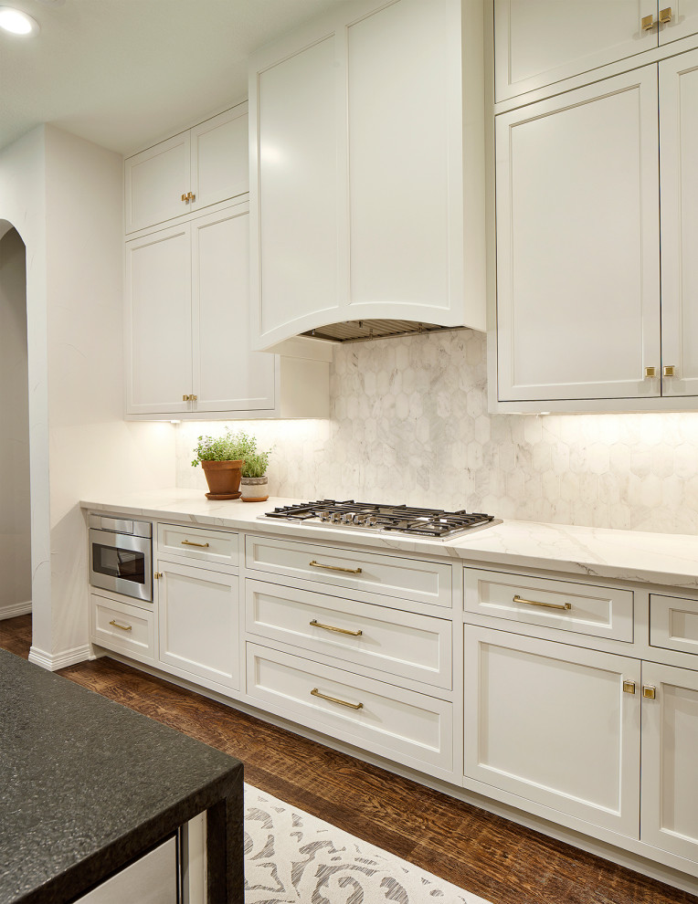 This is an example of a transitional kitchen in Dallas with beaded inset cabinets, white cabinets, medium hardwood floors and with island.