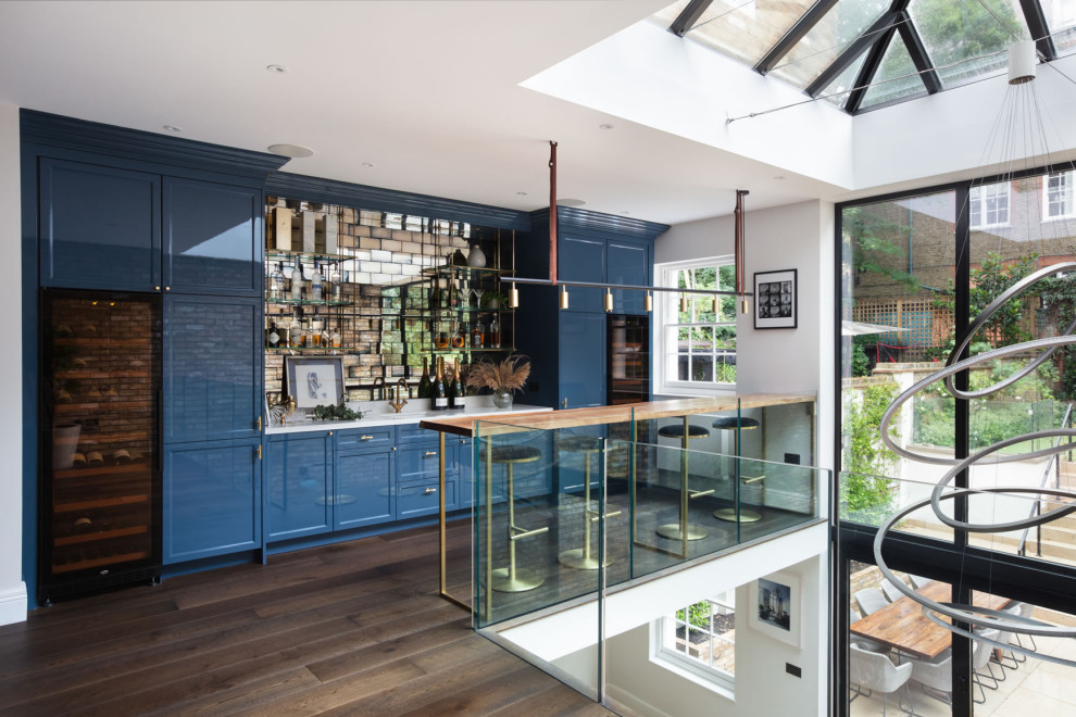Design ideas for a contemporary home bar in London with feature lighting.
