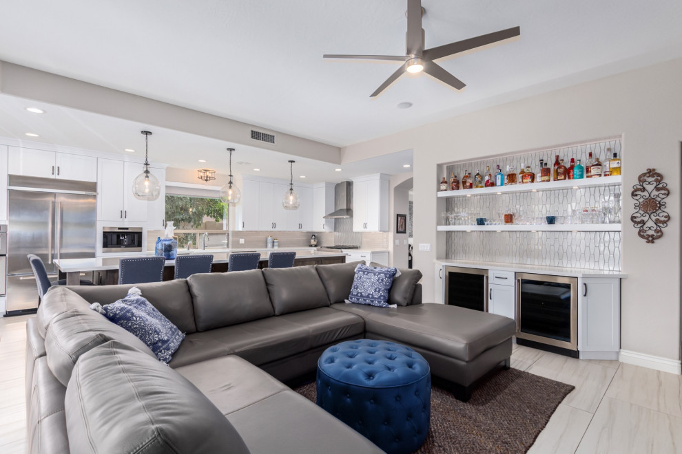 Inspiration for a transitional kitchen remodel in Phoenix with a farmhouse sink, shaker cabinets, white cabinets, gray backsplash, stainless steel appliances and white countertops
