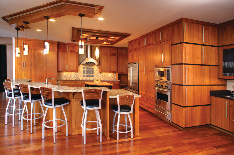 Example of a large transitional l-shaped eat-in kitchen design with shaker cabinets, light wood cabinets, granite countertops, stainless steel appliances and an island