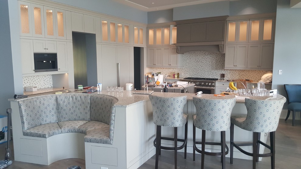 Example of a transitional kitchen design in Miami with shaker cabinets and white cabinets