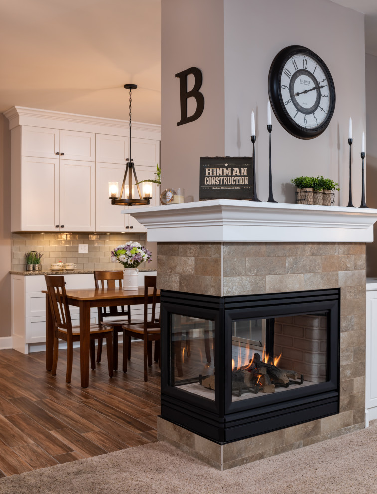 Inspiration for a mid-sized transitional galley open concept kitchen remodel with an undermount sink, shaker cabinets, white cabinets, granite countertops, green backsplash, subway tile backsplash, stainless steel appliances, an island and multicolored countertops