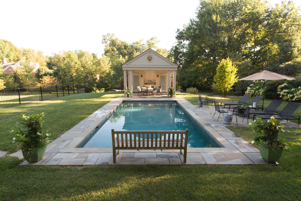 Large elegant backyard concrete paver and rectangular lap pool photo in St Louis