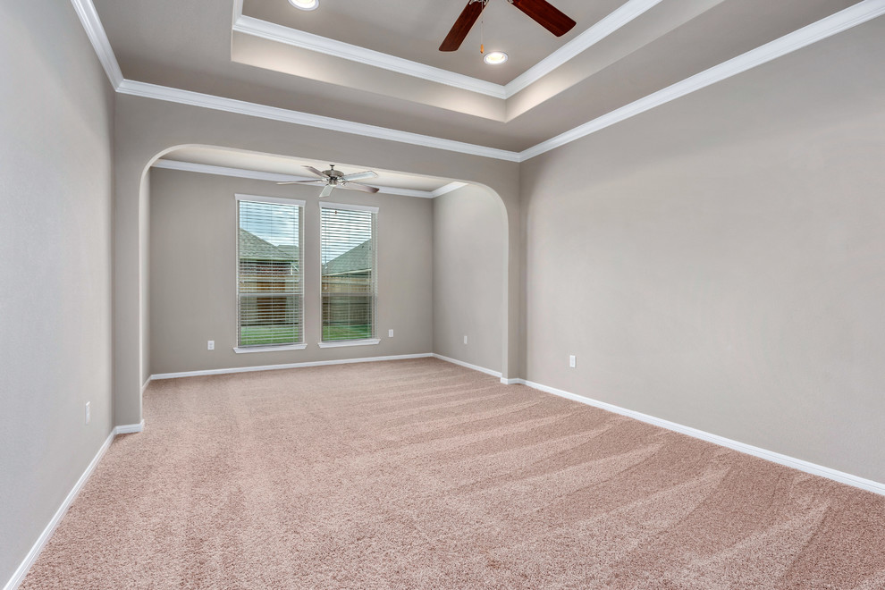 Photo of a mid-sized arts and crafts master bedroom in Austin with grey walls, carpet, no fireplace and beige floor.