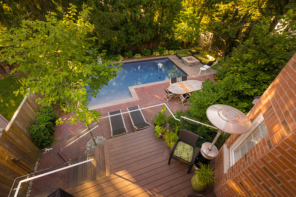 Mid-sized transitional backyard brick and l-shaped natural hot tub photo in Toronto