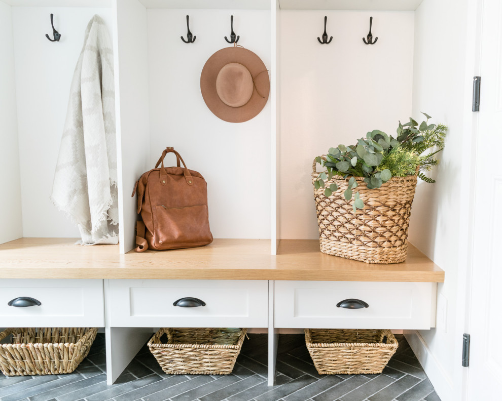 Mid-sized transitional porcelain tile and gray floor mudroom photo with white walls and a white front door