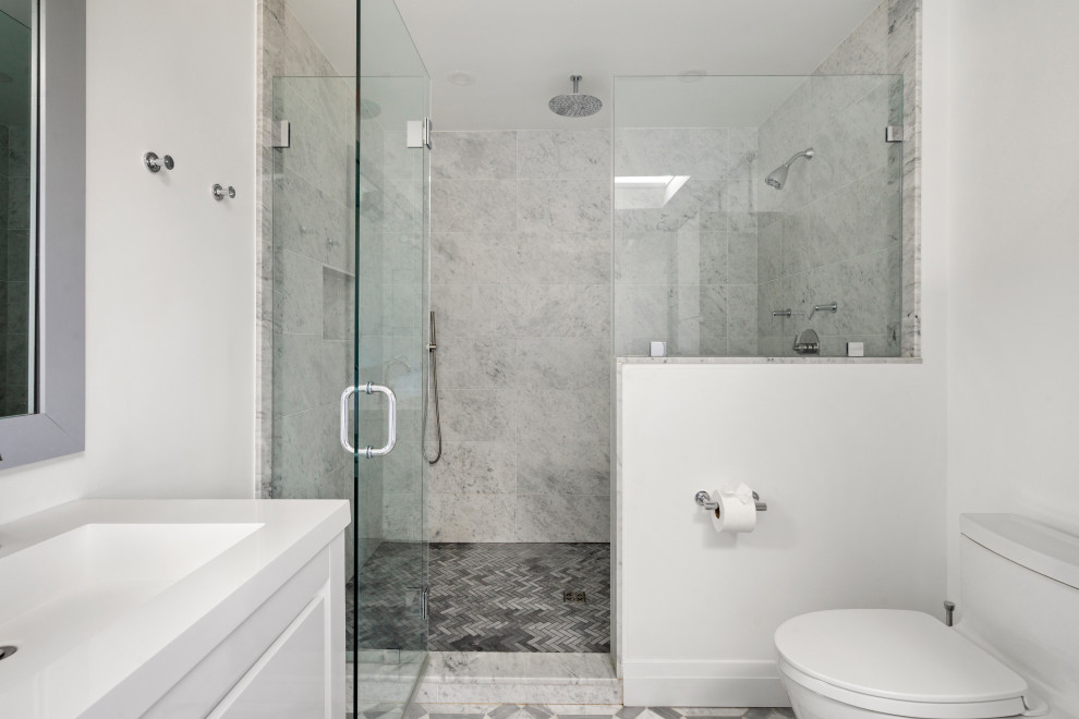 Inredning av ett modernt mellanstort vit vitt en-suite badrum, med släta luckor, vita skåp, ett fristående badkar, en kantlös dusch, grå kakel, marmorkakel, vita väggar, marmorgolv, ett konsol handfat, grått golv och dusch med gångjärnsdörr