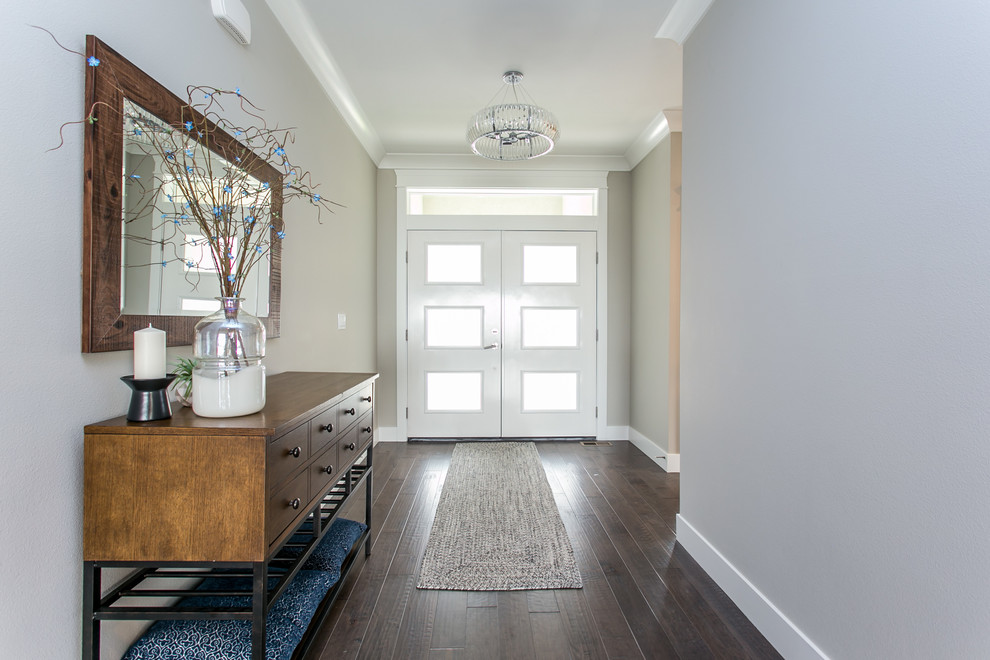 Example of a large transitional dark wood floor foyer design in Seattle with gray walls and a white front door