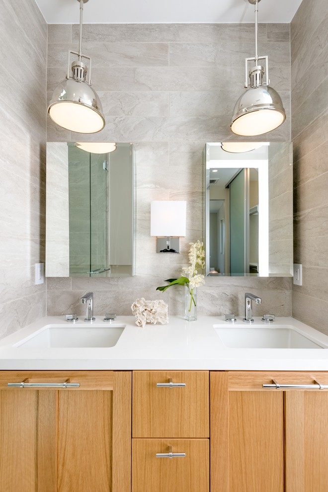 Inspiration for a beach style bathroom in Los Angeles with an undermount sink, shaker cabinets and medium wood cabinets.