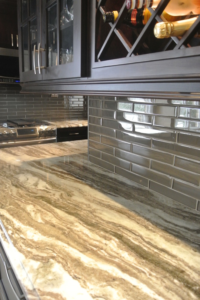 Mid-sized transitional u-shaped eat-in kitchen photo in Toronto with an undermount sink, shaker cabinets, dark wood cabinets, quartzite countertops, stainless steel appliances and an island
