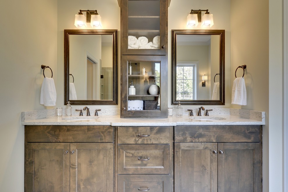Inspiration for a large transitional master bathroom in Minneapolis with an undermount sink, recessed-panel cabinets, dark wood cabinets, a freestanding tub, a corner shower, brown tile and beige walls.