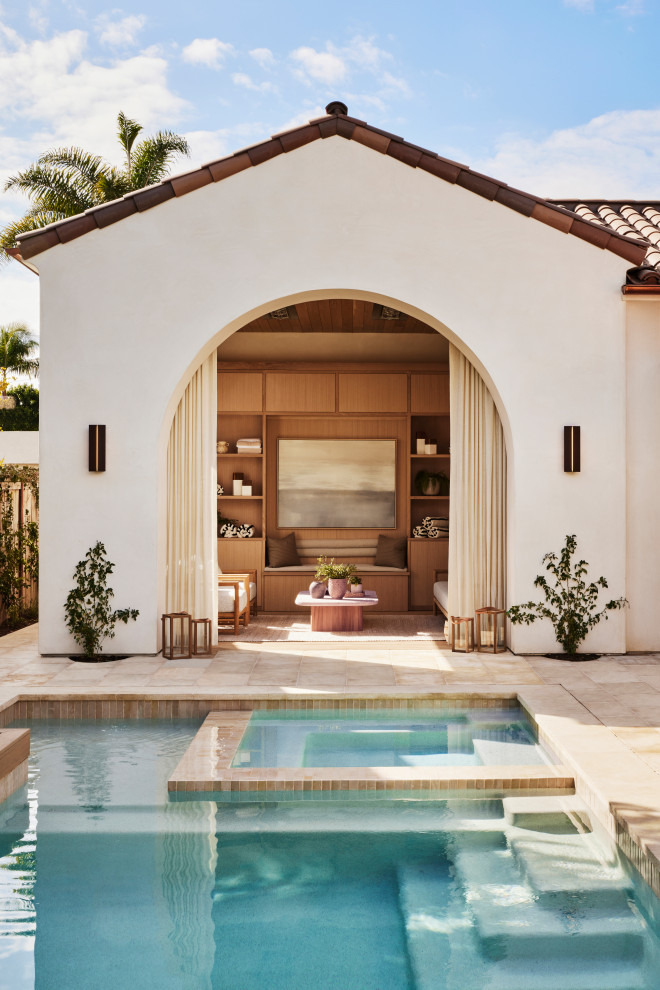 Pool - mediterranean tile and rectangular pool idea in Orange County