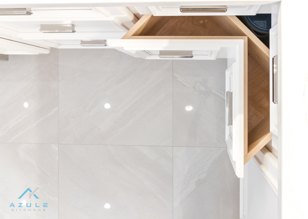Example of a large transitional u-shaped porcelain tile enclosed kitchen design with recessed-panel cabinets, white cabinets, quartz countertops, white backsplash, marble backsplash, stainless steel appliances, an island and white countertops