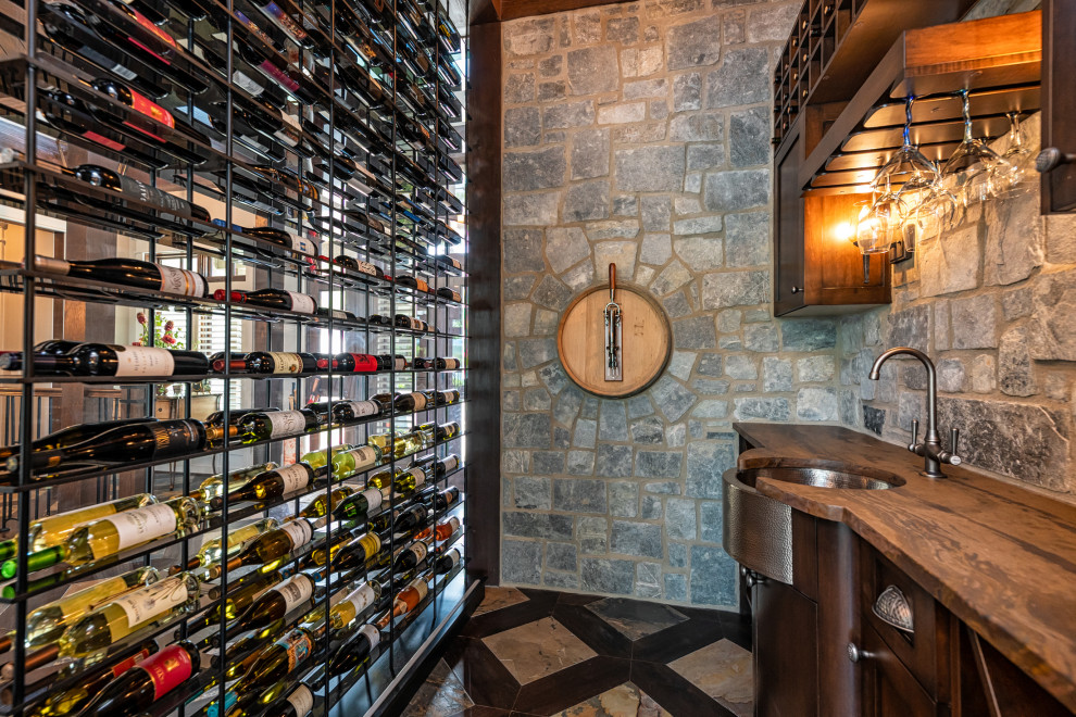Example of a mountain style wine cellar design in Other