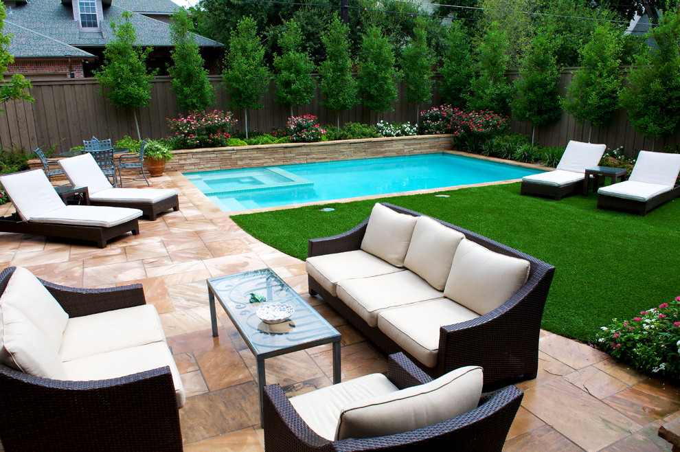 This is an example of a small transitional backyard rectangular pool in Dallas with a hot tub and natural stone pavers.