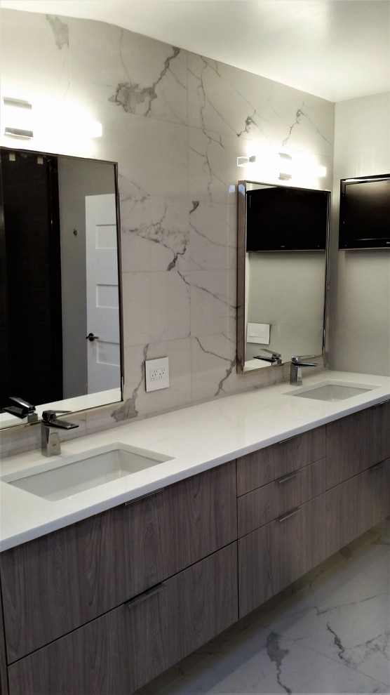 Photo of a large contemporary master bathroom in New York with flat-panel cabinets, grey cabinets, an alcove shower, a bidet, white tile, porcelain tile, grey walls, porcelain floors, an undermount sink and glass benchtops.