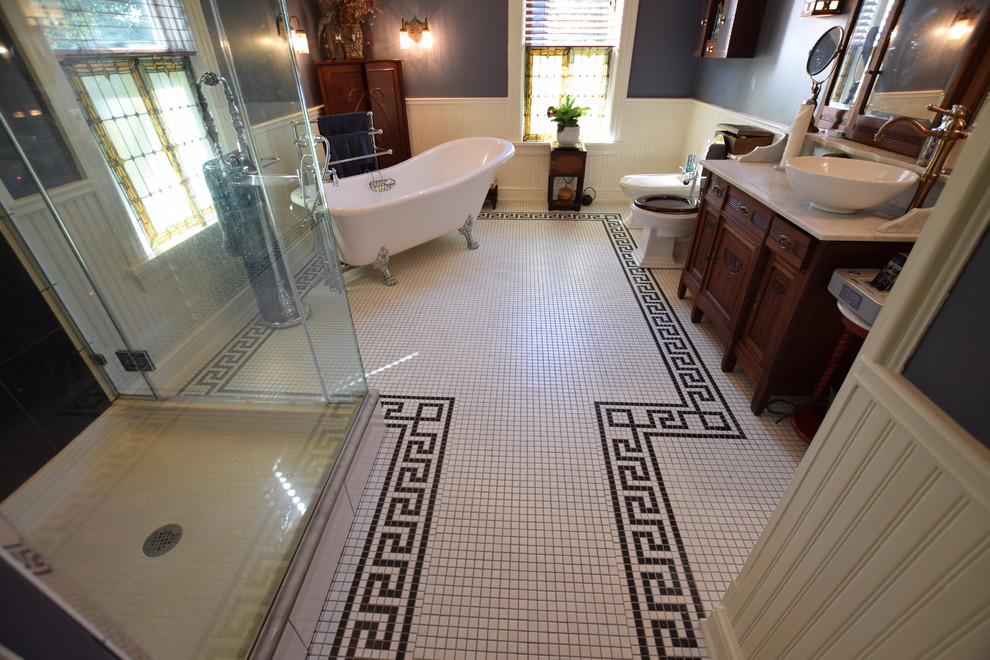 Mid-sized traditional master bathroom in New York with furniture-like cabinets, medium wood cabinets, quartzite benchtops, a claw-foot tub, a corner shower, a two-piece toilet, grey walls, mosaic tile floors, a vessel sink, multi-coloured floor and a hinged shower door.