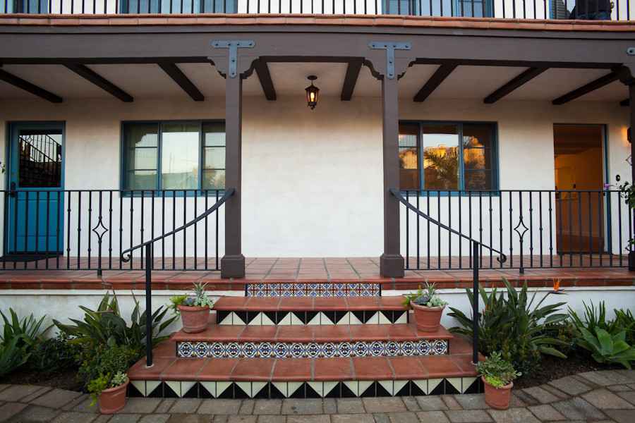 Tuscan tile metal railing porch photo in Santa Barbara with an awning