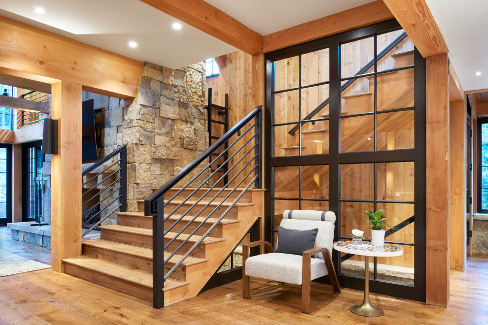 This is an example of a country wood l-shaped staircase in Denver with wood risers and metal railing.