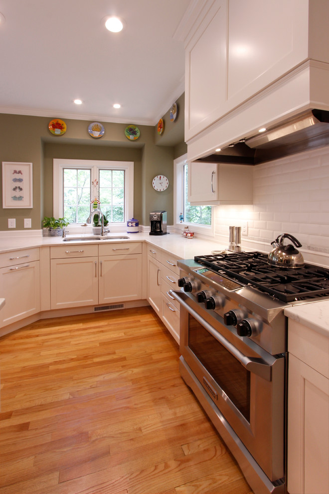 Inspiration for a large transitional u-shaped kitchen in Raleigh with shaker cabinets, white cabinets, stainless steel appliances and with island.