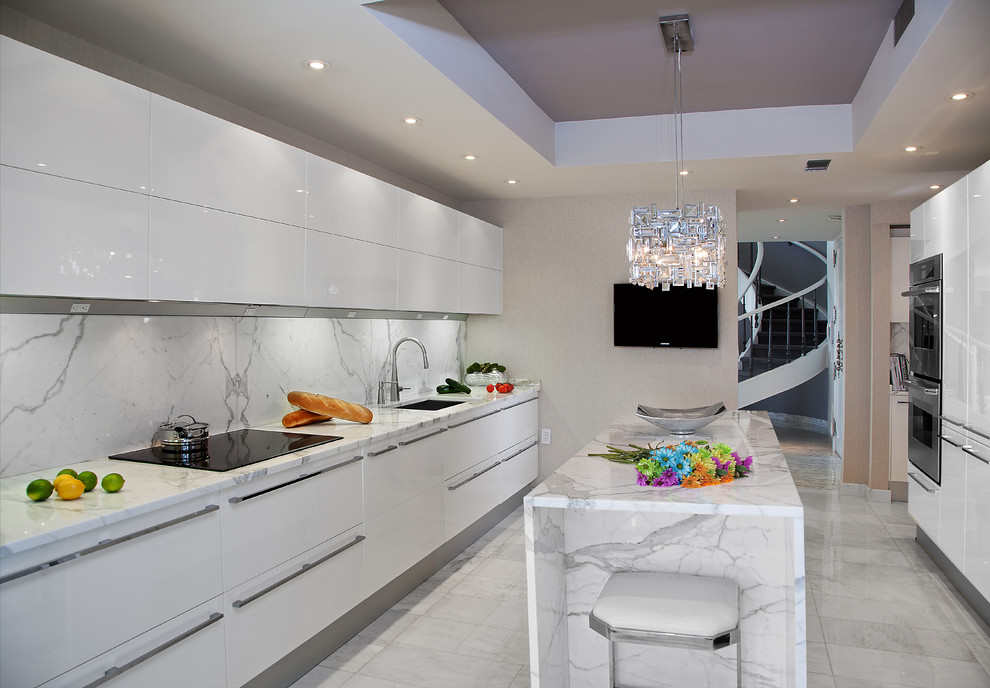 Design ideas for a mid-sized contemporary galley kitchen in New York with an undermount sink, flat-panel cabinets, white cabinets, marble benchtops, white splashback, stone slab splashback and marble floors.
