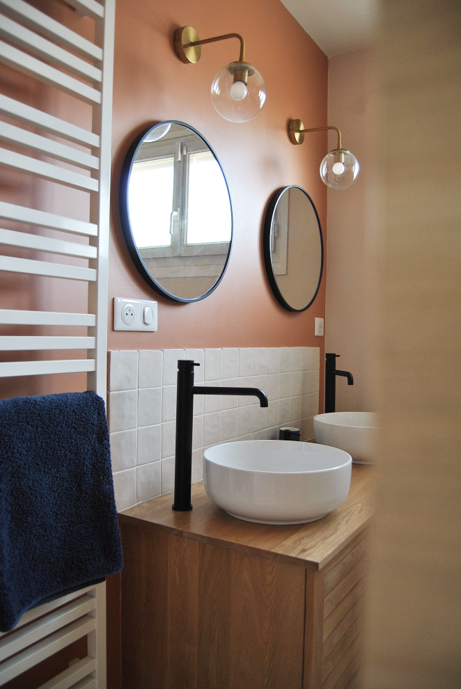 Foto på ett mellanstort nordiskt en-suite badrum, med skåp i ljust trä, en öppen dusch, vit kakel, keramikplattor, orange väggar, klinkergolv i keramik, ett nedsänkt handfat, träbänkskiva och flerfärgat golv