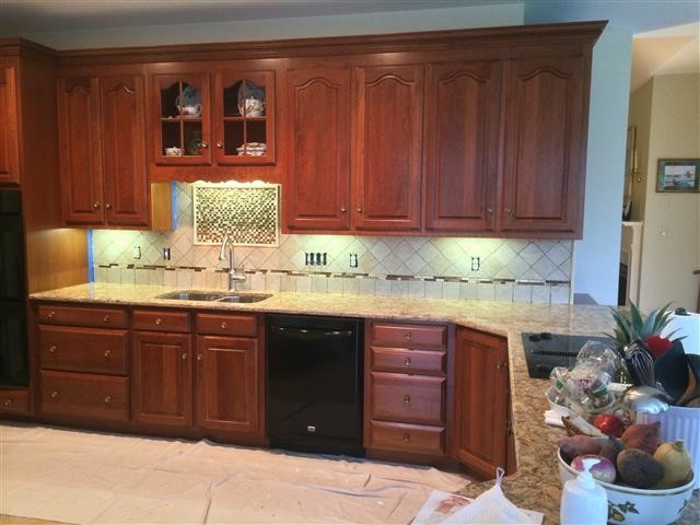 Kitchen - kitchen idea in DC Metro with beaded inset cabinets, medium tone wood cabinets and beige backsplash