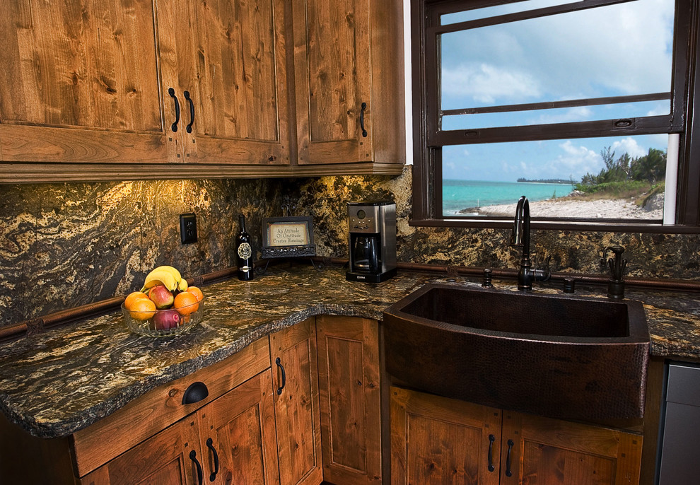 Inspiration for a rustic kitchen remodel in Orange County with a farmhouse sink, shaker cabinets, distressed cabinets, granite countertops and stone slab backsplash