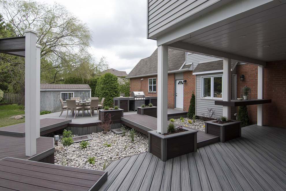 Inspiration for a mid-sized contemporary backyard deck in Toronto with an outdoor kitchen and a pergola.