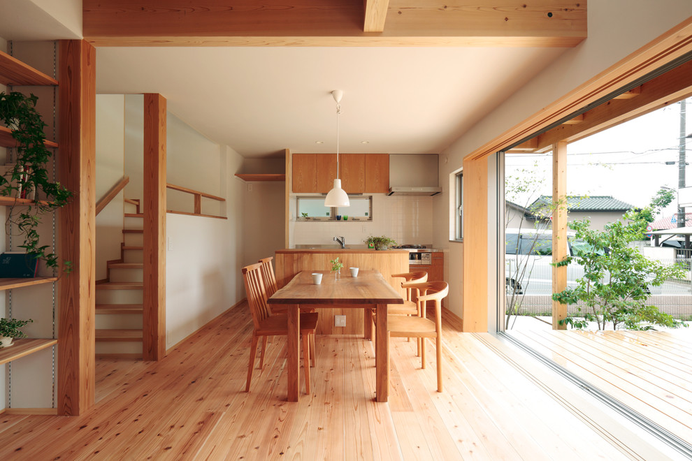 Inspiration for a contemporary open plan dining in Tokyo Suburbs with white walls and light hardwood floors.