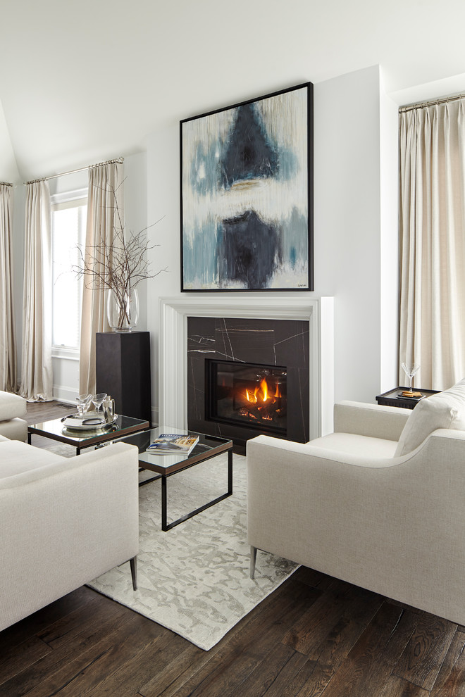 This is an example of a large transitional open concept living room in Toronto with white walls, medium hardwood floors, a standard fireplace, a tile fireplace surround, no tv and brown floor.