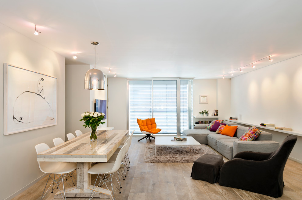 This is an example of a contemporary open concept living room in Tel Aviv with white walls.
