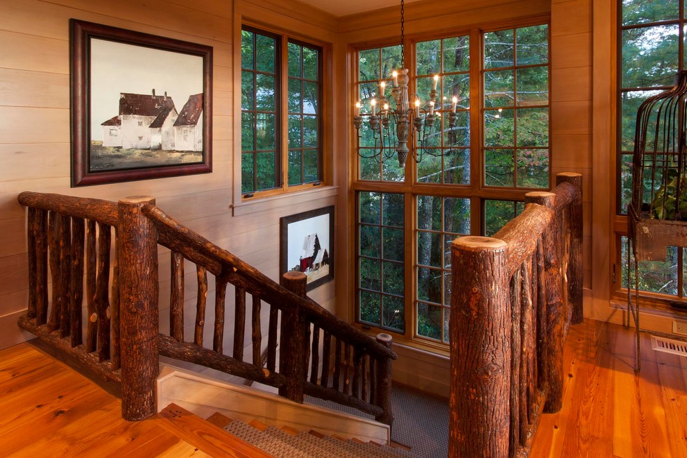 This is an example of a country wood u-shaped staircase in Other with wood railing.