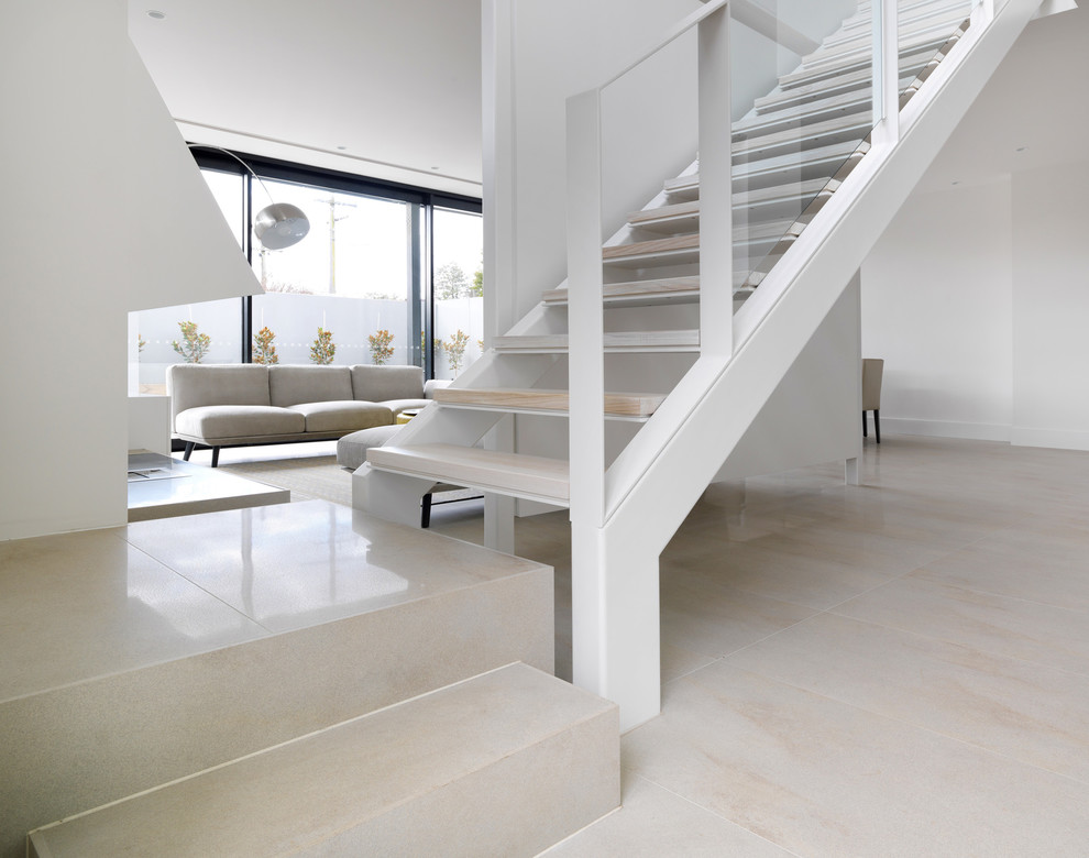 This is an example of a mid-sized contemporary wood straight staircase in Melbourne.