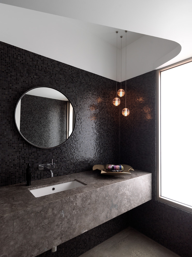 Design ideas for a contemporary bathroom in Sydney with an undermount sink, black tile and black walls.