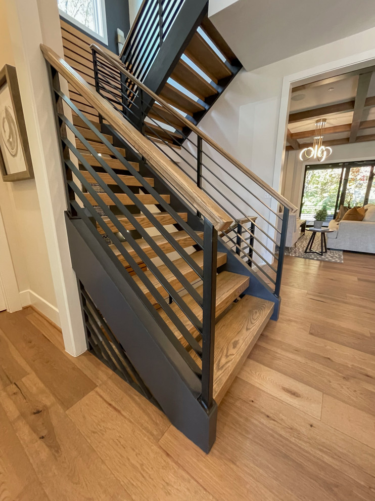 Design ideas for a large contemporary wood straight mixed railing staircase in DC Metro with panelled walls.