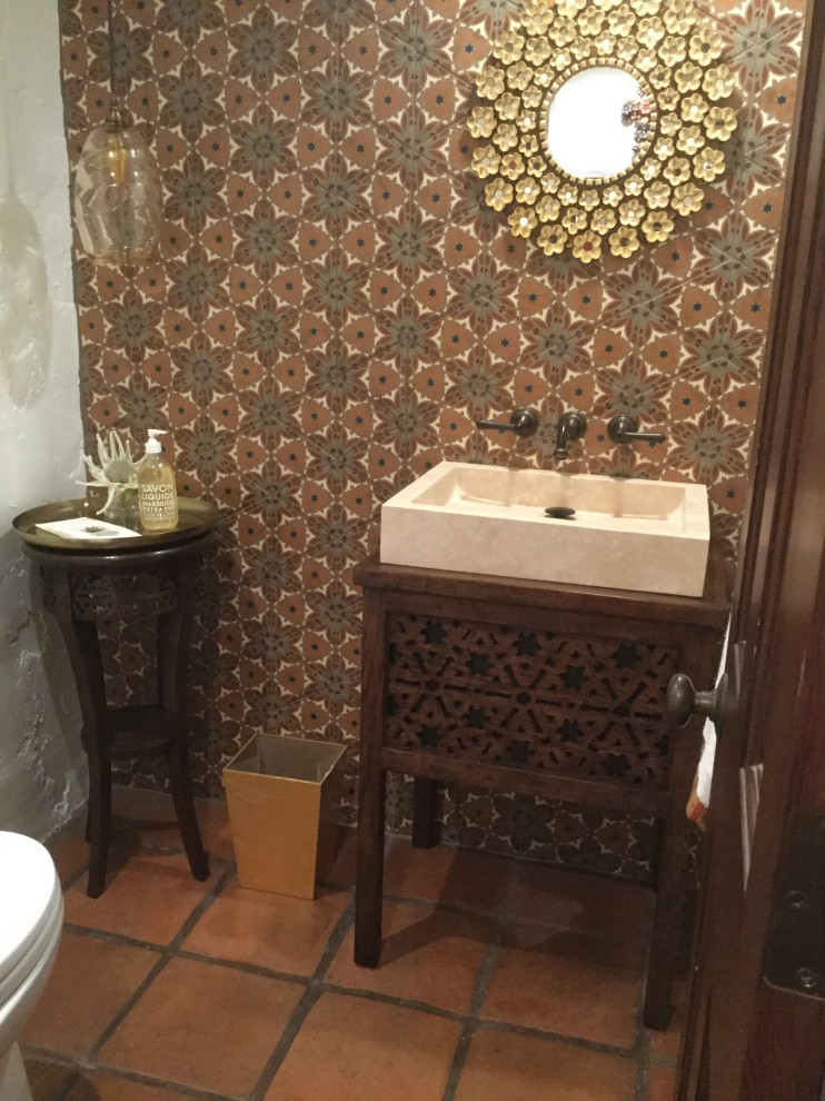 This is an example of a small cloakroom in San Diego with freestanding cabinets, dark wood cabinets, multi-coloured tiles, cement tiles, white walls, terracotta flooring, a vessel sink, wooden worktops, orange floors, brown worktops and a freestanding vanity unit.