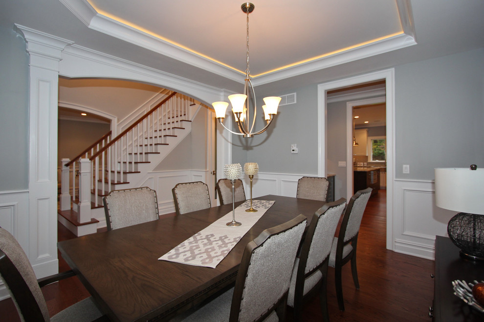 Large transitional separate dining room in New York with grey walls, dark hardwood floors and no fireplace.