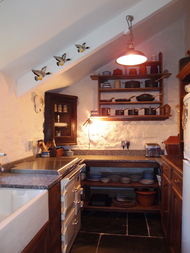 Foto på ett avskilt, litet rustikt grå u-kök, med en rustik diskho, skåp i shakerstil, skåp i mörkt trä, granitbänkskiva, vita vitvaror, skiffergolv och grått golv