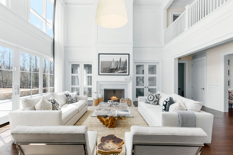 Inspiration for a large beach style formal open concept living room in New York with white walls, a standard fireplace, dark hardwood floors, a tile fireplace surround, no tv and brown floor.