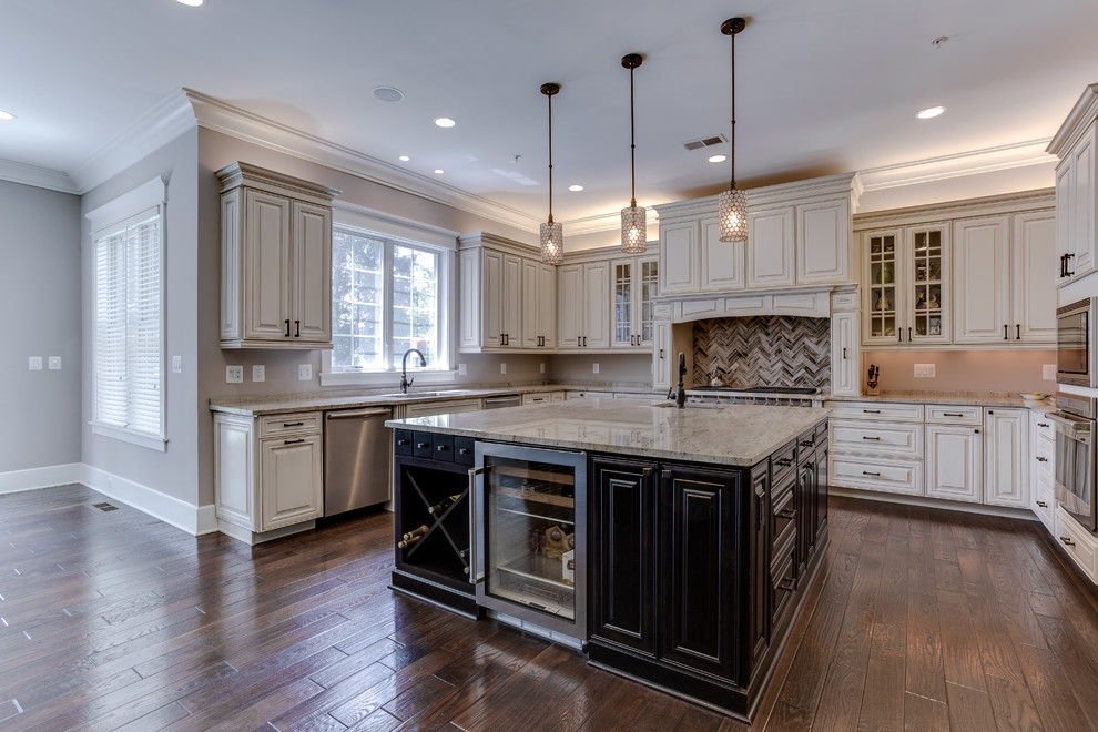 Inspiration for a large u-shaped eat-in kitchen in DC Metro with a drop-in sink, raised-panel cabinets, distressed cabinets, granite benchtops, grey splashback, mosaic tile splashback, stainless steel appliances, medium hardwood floors and multiple islands.