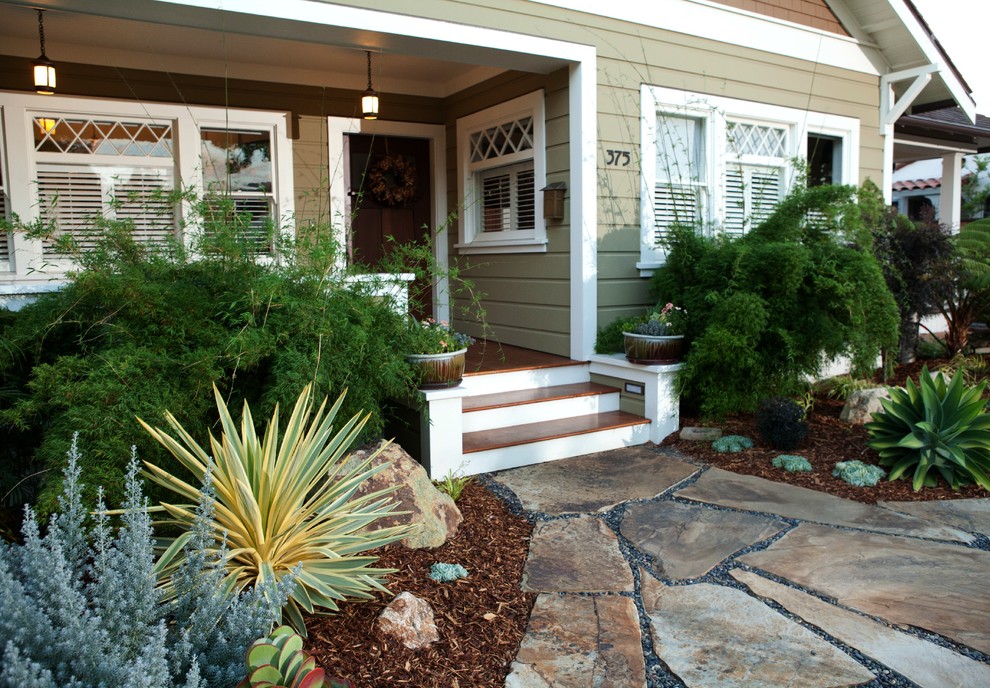 Photo of a mediterranean front yard xeriscape in San Luis Obispo with natural stone pavers.