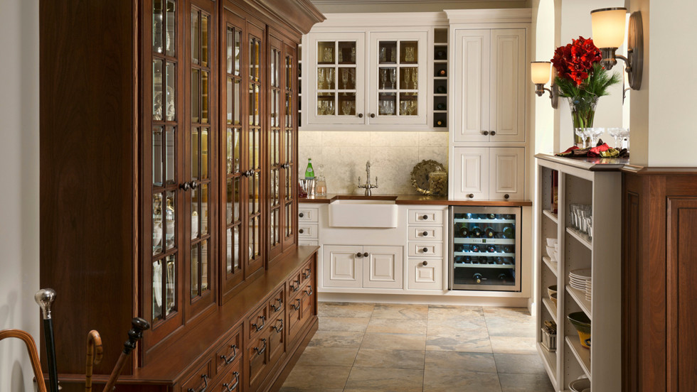 Design ideas for a mid-sized traditional kitchen pantry in Houston with a drop-in sink, beaded inset cabinets, white cabinets, solid surface benchtops, white splashback, stainless steel appliances and terra-cotta floors.