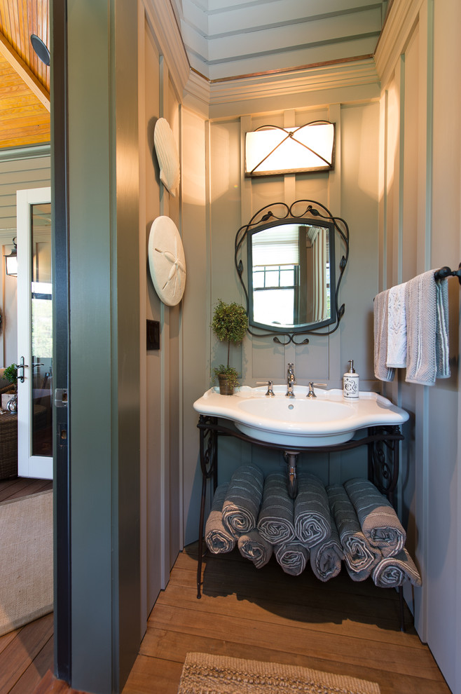 Inspiration for a traditional bathroom in Charleston with a console sink and blue walls.