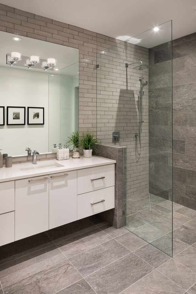 This is an example of a mid-sized contemporary bathroom in Vancouver with flat-panel cabinets, light wood cabinets, a one-piece toilet, yellow tile, ceramic tile, light hardwood floors and a vessel sink.