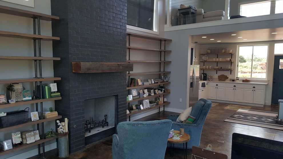Inspiration for a mid-sized country enclosed living room in Oklahoma City with white walls, concrete floors, a standard fireplace, a brick fireplace surround, no tv and brown floor.