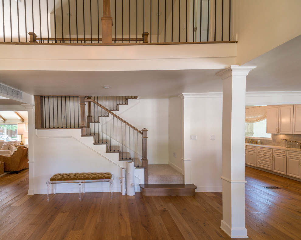 Inspiration for a transitional carpeted l-shaped mixed material railing staircase remodel with carpeted risers
